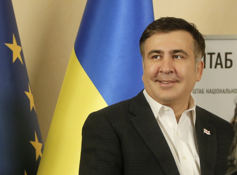 Former Georgian president Mikhail Saakashvili smiles as he arrived at the opposition headquarters in Kiev, Ukraine, Saturday, Dec. 7, 2013. As thousands of anti-government protesters kept their vigil in Ukraine's capital Saturday, officials sought to reduce their anger with assurances that Russian and Ukrainian presidents didn't discuss Ukraine joining a Russian-led customs union at a meeting this week. (AP Photo/Efrem Lukatsky)